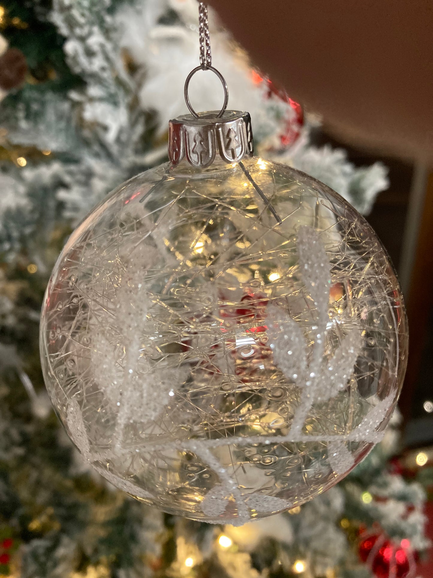 Glass bauble with silver leaves and strands